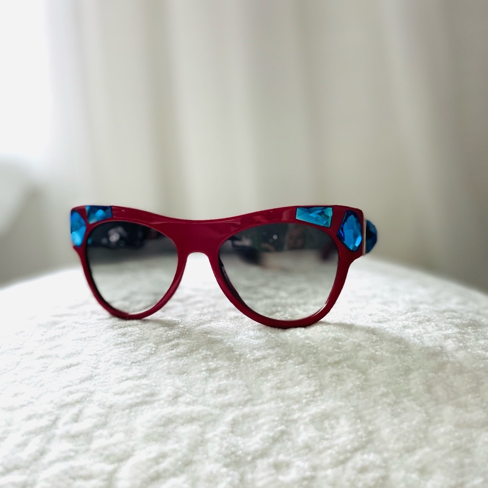 New authentic Prada sunglasses in red with blue stones.